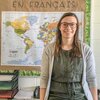 Headshot of Laura Furrer in front of world map